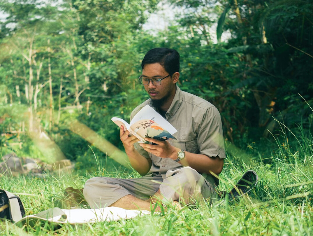 person reading book thoughtfully